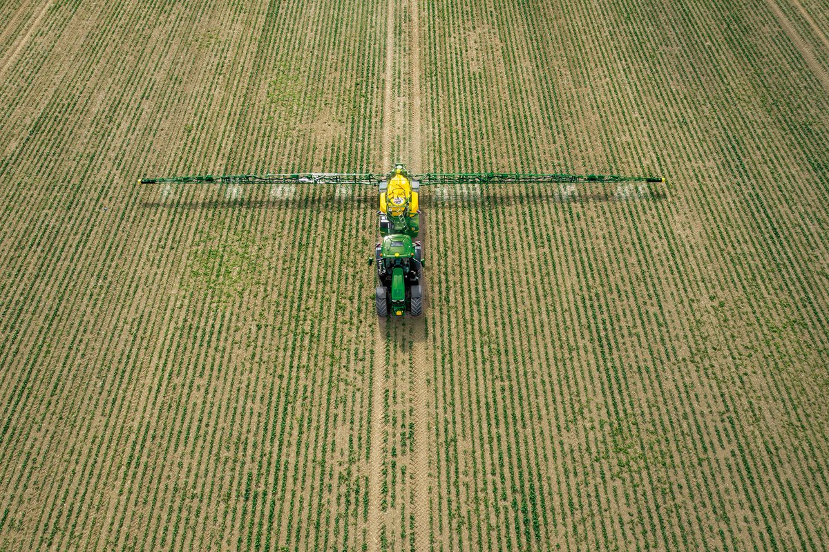 Sprayer working a crop field from above